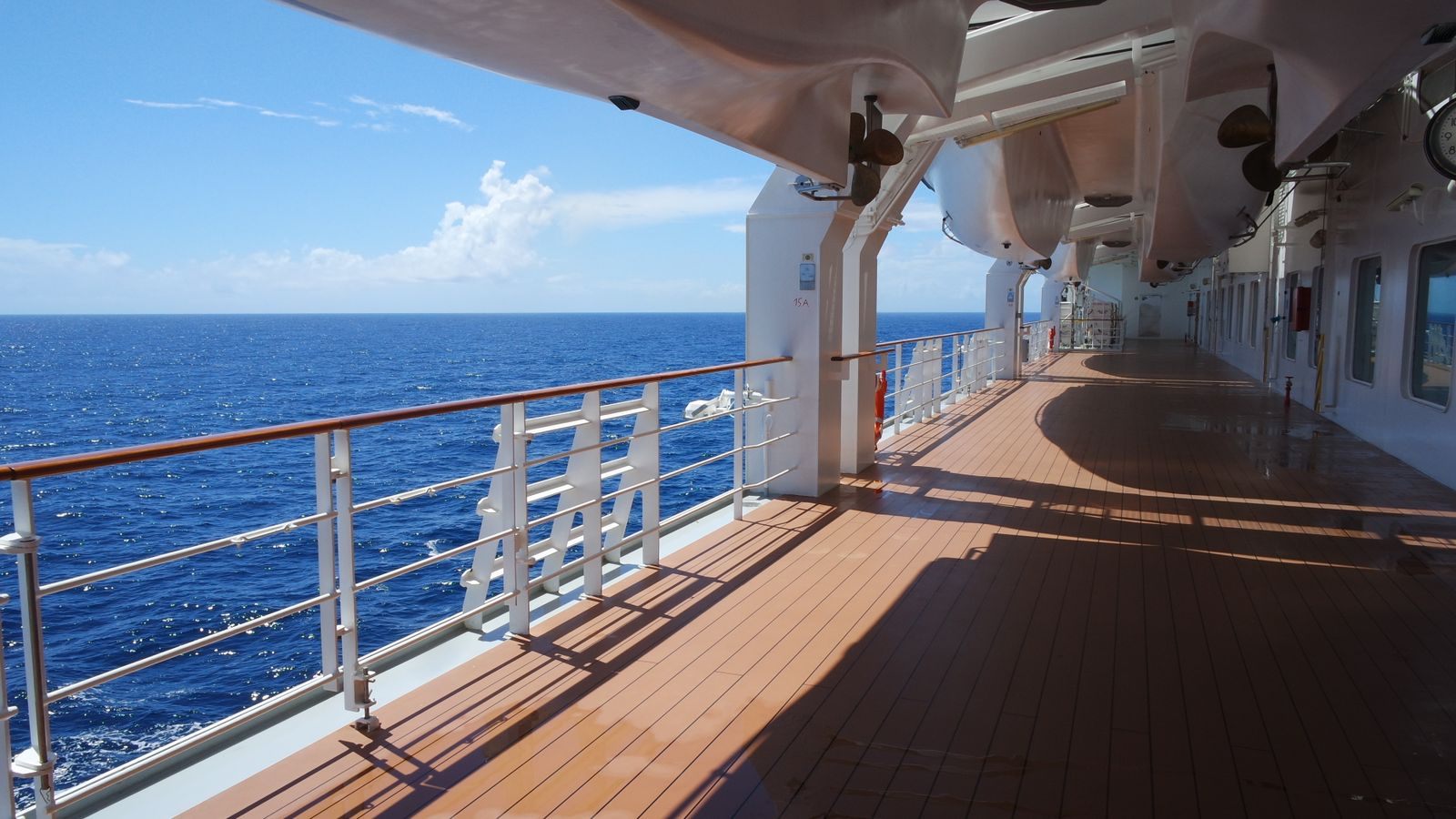 Cruise ship deck overlooking blue ocean water