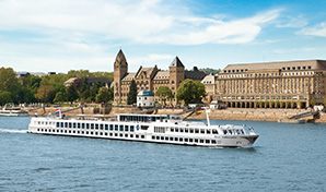 River cruise ship passing a riverside castle